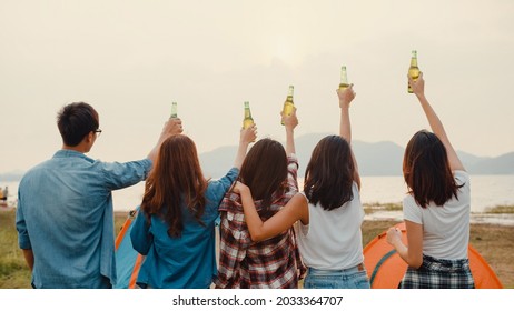 Group Of Asia Best Friends Teenagers Salute And Cheers Toast Of Bottle  Beer Enjoy Party With Happy Moments Together In National Park Camp. On The Background Beautiful Nature, Mountains And Lake.