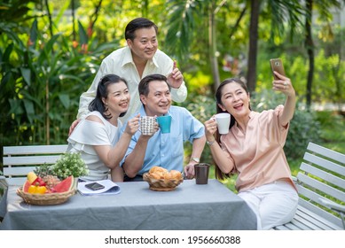 Group Of Asia Family And Friends Happiness Meeting, Lifestyle People Middle Age Outdoor Party. Communication Social Online Life Of Asian People.