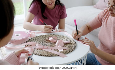 Group Asia Happy People Senior Mature Lady And Teen Girl Sit At Home Sofa Write Cheer Up Sign Symbol Quote On Bow Tied In Program Workshop Class To Help Fight Prevent Female Disease Issue Health Care.