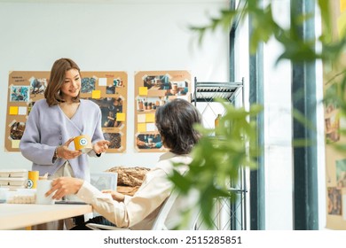 Group of Asian business people creative teamwork meeting discussion about reusable eco friendly innovations packaging product for sustainable life, environmental conservation in office conference room - Powered by Shutterstock