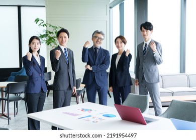 Group Of Asian Business People Fist Pump In The Office