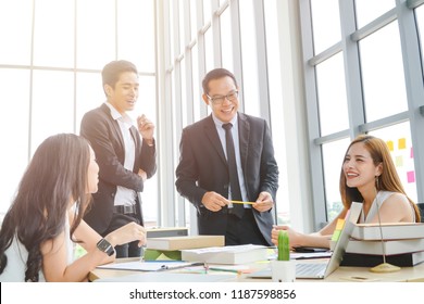 Group Of Asian Business People Having A Casual Discussion.