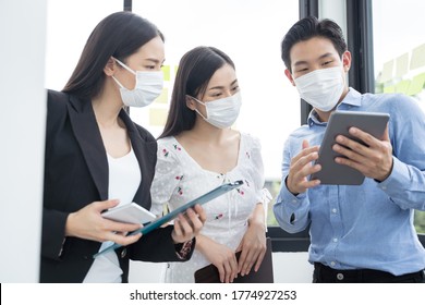 Group of asian business people meeting and working in office and wear mask for protect prevent infection corona virus covid 19. - Shutterstock ID 1774927253