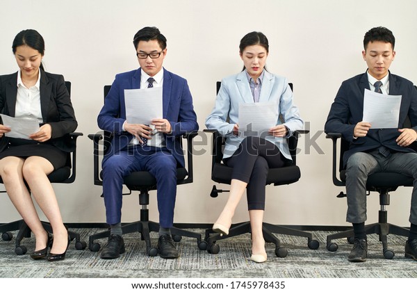 group of asian business people men and women
waiting in line for job
interview