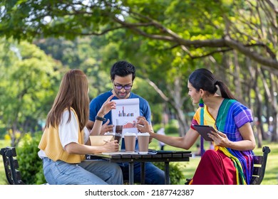 Group Of Asian Business Startup People Having A Meeting Project Outside In The Public Park During The Summer For College Education And Brainstorming Concept