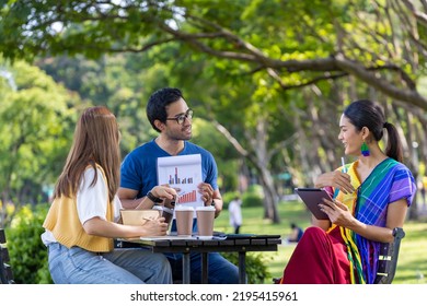 Group Of Asian Business Startup People Having A Meeting Project Outside In The Public Park During The Summer For College Education And Brainstorming Concept