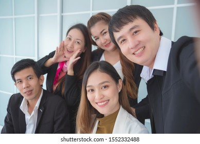 Group Of Asian Business Team Happy And Smile While Taking Selfie By Smartphone In The Office, Business People Concept.