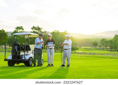 Group of Asian businessman and senior CEO talking together during golfing on golf course. Healthy retired elderly people enjoy outdoor activity lifestyle at country club on summer holiday vacation. - Powered by Shutterstock