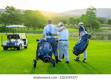 Group of Asian businessman and senior CEO holding golf bag walking on golf course with talking together. Healthy people enjoy outdoor sport lifestyle golfing at country club on summer holiday vacation - Powered by Shutterstock