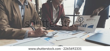 A group of Asian businessmen are meeting, planning and discussing data analysis, growth charts, graphs, financial calculations, marketing, revenue management. Various taxes within the joint office.