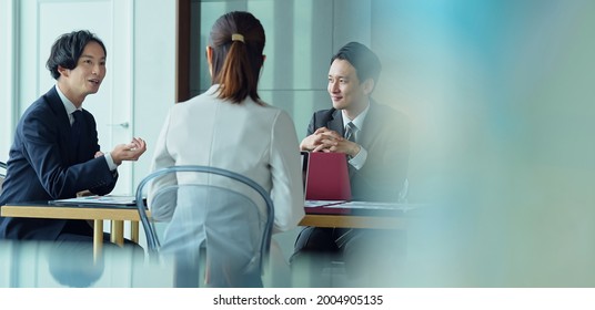 Group Of Asian Businessperson Meeting In The Office. Group Discussion. Management Strategy. Brainstorming.