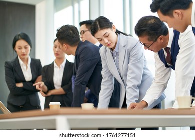 Group Of Asian Corporate Executives Meeting In Office To Discussing Business Performance