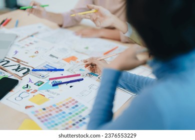 Group of asian creative team programing designers participate in all phases of the UX UI design