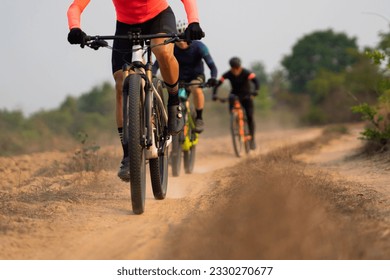 Group of Asian cyclists, they cycle through rural and forest roads. - Shutterstock ID 2330270677