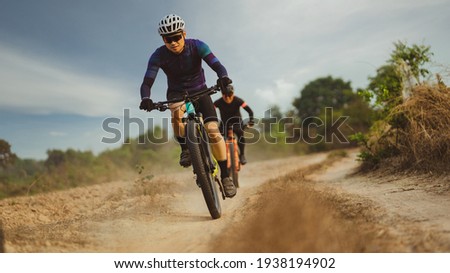 Group of Asian cyclists, they cycle through rural and forest roads.