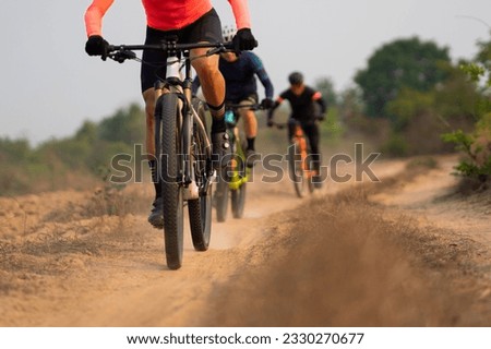 Group of Asian cyclists, they cycle through rural and forest roads.
