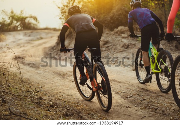 Group of Asian cyclists, they cycle through rural\
and forest roads.