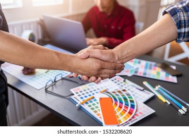 Group of Asian designers shook hands after meeting after choosing the color of the finished product. Happy Concept. - Powered by Shutterstock