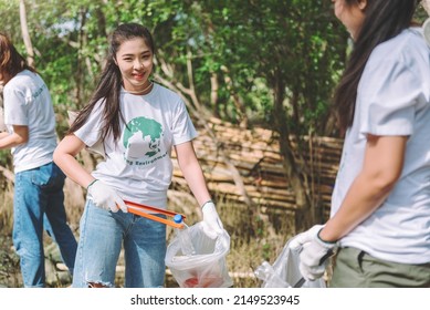 Group of asian diverse people volunteer teamwork ,environment conservation,volunteer help to picking plastic and foam garbage on park area.Volunteering world environment day.