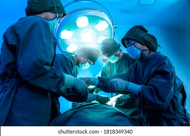 Group Of Asian Doctor And Nurse Surgeons In Hospital Operating Theater. Medical Team Performing Surgery In Operation Room.Medical Team Doing Critical Operation.health And Wellness Concept