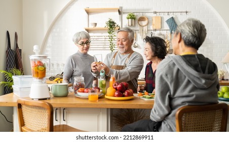 Group of Asian elder people friends making vegetables salad and fruit juice with her daughter in kitchen at home.concept of Group asia senior people Healthy eating,colorful fruits and vegetables. - Powered by Shutterstock