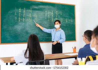 Group Of Asian Elementary School Students And Teacher Wearing Hygienic Mask To Prevent The Outbreak Of Covid 19 In Classroom While Back To School Reopen Their School, New Normal For Education Concept.