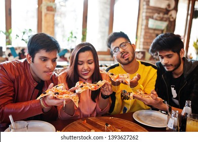 Group Of Asian Friends Eating Pizza During Party At Pizzeria. Happy Indian People Having Fun Together, Eating Italian Food And Sitting On Couch.