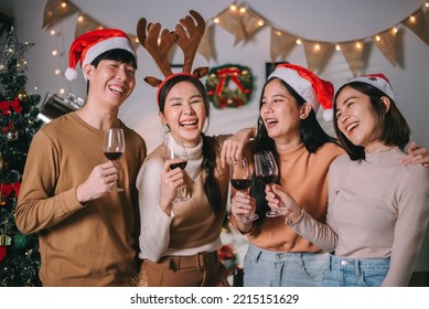 Group of asian friends enjoying christmas party and drinking wine for new year celebrate. Friends having fun together at home. - Powered by Shutterstock