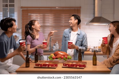 Group of Asian friends enjoying an evening party together at home. - Powered by Shutterstock