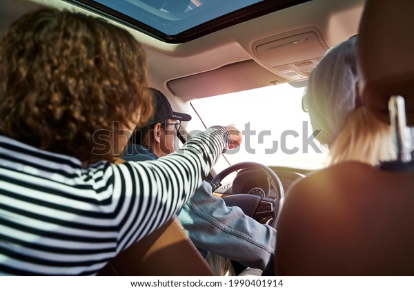 group
of asian friends enjoying a sightseeing trip by
car