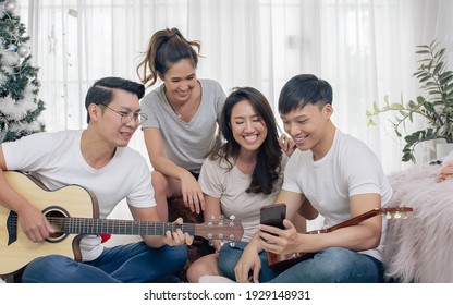 Group Of Asian Friends Having Party, Playing Guitar And Singing Together With Fun At Home. Lifestyle Concept.