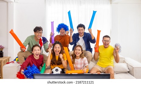 Group of Asian man and woman friends watching soccer games world cup competition on television with eating snack together at home. Sport fans people shouting and celebrating sport team victory match. - Powered by Shutterstock