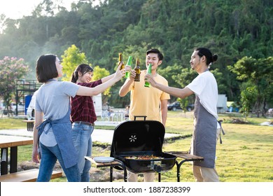 Group of Asian man and woman are having new year party outdoor in the evening together. Friends are drinking bottle of beer and drinking with happiness and smile. Travel nature, camping on camper van. - Powered by Shutterstock