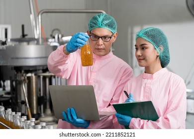 Group of asian manufacturer checking product bottles on the conveyor belt in the beverage factory. Manufacturer and Inspection quality control - Powered by Shutterstock