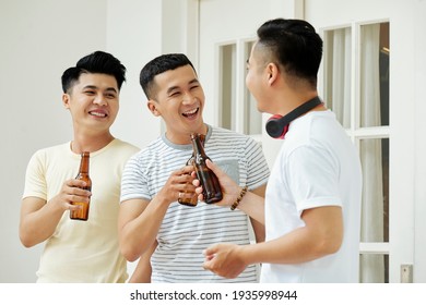 Group Of Asian Men Having Fun Together While Drinking Beer At Home