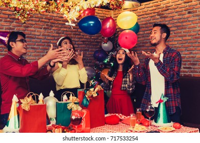 Group Of Asian Men And Women Enjoying Celebration Party Christmas And Happy New Year.