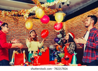 Group Of Asian Men And Women Enjoying Celebration Party Christmas And Happy New Year.