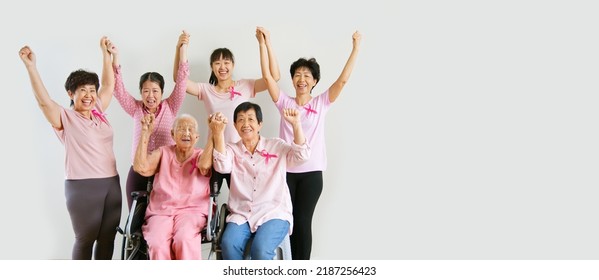 Group of Asian multi-age women power in pink shirt and pink ribbon for October Breast Cancer Awareness month with banner copy space - Shutterstock ID 2187256423