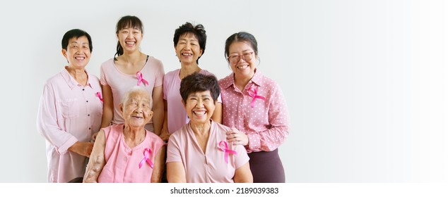 Group Of Asian Multi-age Women Power In Pink Shirt And Pink Ribbon For October Breast Cancer Awareness Month With Banner Copy Space