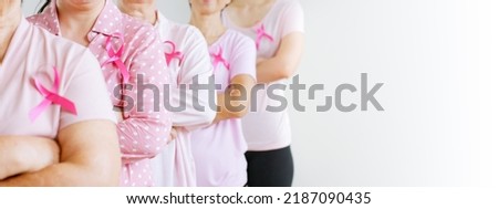 Group of Asian multi-age women power in pink shirt and pink ribbon for October Breast Cancer Awareness month with banner copy space