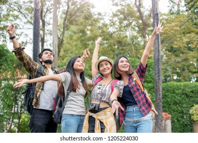 Group Asian People With Backpack Summer Outdoor And Happy Are Taking Photo At Forest In The Evening; Attractive Young Trusted Spend Time Together; Relax Time On Holiday Concept Travel