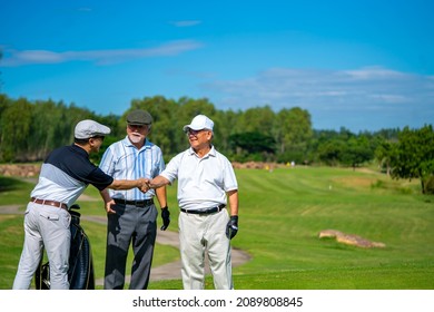 Group Of Asian People Businessman And Senior CEO Enjoy Outdoor Sport Lifestyle Golfing Together At Golf Country Club. Healthy Men Golfer Shaking Hand After Finish Game On Golf Course At Summer Sunset