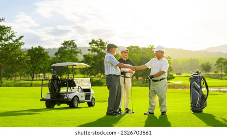 Group of Asian people businessman and senior CEO shaking hands after success business agreement and golf game at country club. Healthy elderly people enjoy outdoor sport lifestyle on summer vacation. - Powered by Shutterstock