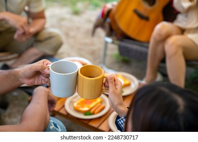 Group of Asian people enjoy and fun outdoor lifestyle travel nature and camping together on summer travel vacation. Man and woman friends having breakfast and drinking coffee at camp in the morning - Powered by Shutterstock