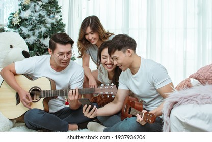 Group Of Asian People Or Friends Having Party, Singing And Dancing Together In Living Room At Home. Lifestyle Concept.