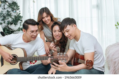 Group Of Asian People Or Friends Having Party, Singing And Dancing Together In Living Room At Home. Lifestyle Concept