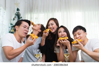 Group Of Asian People Or Friends  Joining Party At Cozy Indoor Home, Talking And Eating Pizza Together With Happiness And Fun. Lifestyle Concept