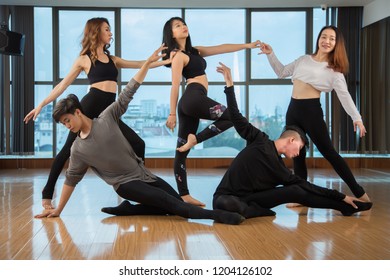 Group Of Asian People Performing Beautiful Contemporary Dance In Stylish Modern Studio