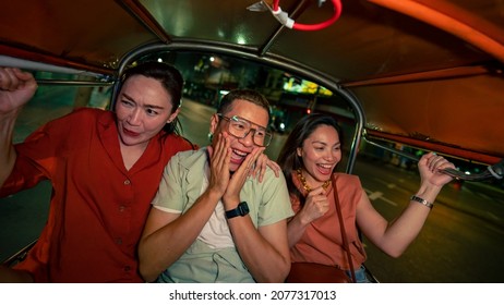 Group Of Asian People Tourist Traveling In Bangkok City By Tuk Tuk Taxi Car Together At Night. Male And Female Friends Enjoy And Having Fun Outdoor Lifestyle Travel City Street Nightlife In Thailand.