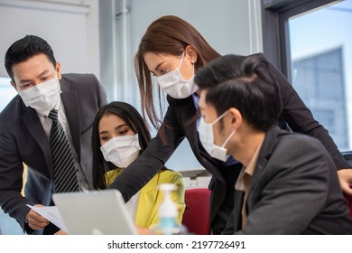 Group of Asian people wearing protective mask working and brainstorming in the office meeting room. manager discussing of company project. keep social distancing and new normal at company concept - Shutterstock ID 2197726491